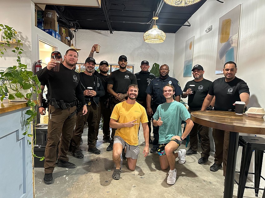 Officers from various departments stopped at Sips in Whitney Plaza, which recently re-opened after the hurricanes. Chris Carter and Lorenzo Condensa (front) said, thanks to a generous donation from a resident, the shop was able to provide free coffee and smoothies to the officers who stopped in.