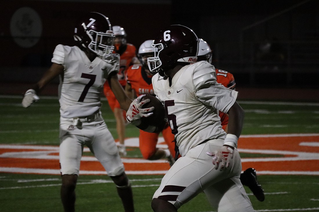 Braden River High junior running back David Louis tries to find a hole against the Sarasota defense.